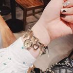 Đồng Hồ Dạng Lắc Anne Klein Women's 10-7604CHRM Swarovski Crystal Gold-Tone Charm Bracelet Watch
